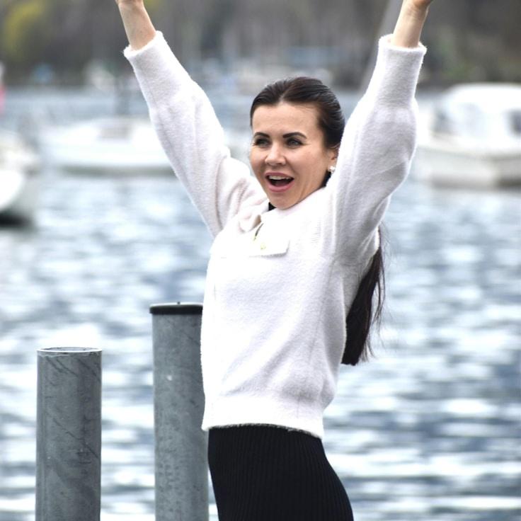 Ava Chen, Lead Design Curator at GoldenCenterSphere, reviewing corporate floral arrangements